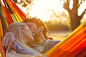 Couple relaxing together in hammock