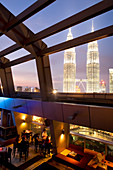 Malaysia, Kuala Lumpur, downtown, the Petronas Twin Towers by architect Cesar Pelli seen from the Traders Hotel's bar, the Sky Bar