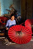 Myanmar (Burma), Shan State, Pindaya, family business manufacturing umbrellas U Ohn Khing, Daw Nyo Ohn U Khing completing the painting of paper