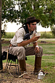 Argentina, Buenos Aires Province, Estancia San Isidro del Llano, gaucho drinking Mate beverage (local herbal tea)