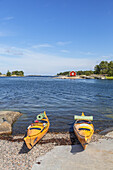 Kayaks on the beach in Langvik, island of Moeja in Stockholm archipelago, Uppland, Stockholms land, South Sweden, Sweden, Scandinavia, Northern Europe