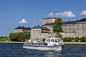 Boat of Stockholm sightseeing in front of fortress Kastell in Vaxholm, Stockholm archipelago, Uppland, Stockholms land, South Sweden, Sweden, Scandinavia, Northern Europe