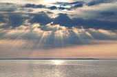 Sun rays come through the clouds in the sky over the Baltic Sea, Island Als, Danish South Sea Islands, Southern Denmark, Denmark, Scandinavia, Northern Europe