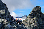 Mehrere Personen stehen in Felsscharte, Klettersteig Sentiero dei Fiori, Adamello-Presanella-Gruppe, Trentino, Italien