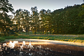 Moat at Raesfeld moated castle, Muensterland, North-Rhine Westphalia, Germany