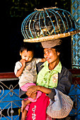 Myanmar (Burma), Mandalay Division, Mandalay, Maha Muni Temple, Ma Ni Ni Aye selling birds to worshippers so that they can be freed according to tradition