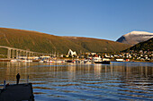 Norway, Troms County, Tromso harbour in Tromsesundet Fjord, the Arctic Cathedral and Tromsdalstind Mount (1238 m) in the background