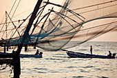 India, Kerala State, Kochi (Cochin), fishermen seen through the Chinese square dipping nets