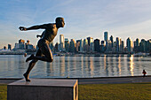 Canada, British Columbia, Vancouver, Stanley Park, the olympic runner Harry Jerome statue and in the background the downtown towers in sunset