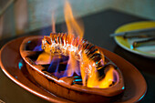 Portuguese sausage is flame-grilled at Restaurante Espaco Lisboa in Coloane Village, Coloane, Macau, China