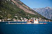 Church on Gospa od Skrpjela island seen from motor sailing cruise ship M/S Panorama (Variety Cruises) in Kotor fjord, Perast, near Kotor, Montenegro