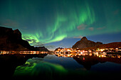 Norway, Nordland County, Lofoten Islands, aurora borealis overhead the fishermen village of Reine