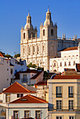 Portugal, Lisbon, roofs of Alfama District and Sao Vicente de Fora Monastery seen from the terrace of Largo das Portas do Sol