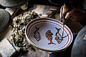 Woman decorating Horezu ceramics, a unique type of Romanian pottery, UNESCO Cultural Heritage List, Wallachia, Romania, Europe