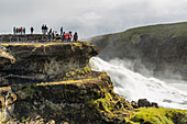Tourists visiting Gullfoss (Golden Falls), a waterfall located in the canyon of the Hvita River in southwest Iceland, Polar Regiions