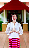 Woman making a Thai Wai salute in Lamphun, Thailand, Southeast Asia, Asia