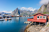 Fishing village and harbour framed by peaks and sea, Hamnoy, Moskenes, Nordland county, Lofoten Islands, Arctic, Northern Norway, Scandinavia, Europe