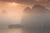 Vietnam, Halong Bay, tourist boats, sunrise.