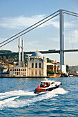 Ortakoy Mosque, Istanbul, Turkey, seen from the Bosphorus. Completed 1856. The First Bosphorus Bridge rises behind.