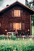 Portrait of a young Mountainbiker, Mountainbike, Hut, Brandnertal, Vorarlberg, Austria