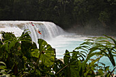 A pair of kayakers drop off a waterfall on the Rio Tulija, also known as Agua Azul in Chiapas, Mexico.