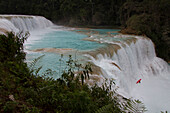 A kayaker has a less than perfect drop off a waterfall on the Rio Tulija, also known as Agua Azul in Chiapas, Mexico.