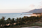 Sunset paints the sands and sea of Sun and Moon Bay on Hainan Island, China.