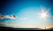 A man flies a kite on White Rock Beach.