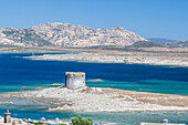 Turquoise sea and old tower surround La Pelosa Beach, Stintino, Asinara National Park, Province of Sassari, Sardinia, Italy, Mediterranean, Europe
