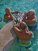 Men play chess at the outdoor pools at the Szechenyi Thermal Baths, Budapest, Hungary, Europe