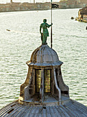 Green statue on top of a dome roof with view of a canal, Venice, Italy
