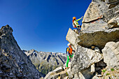 Man and woman climbing on fixed-rope route towards Richterspitze, Richterspitze, Reichenspitze group, Zillertal Alps, Tyrol, Austria