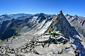 Man and woman ascending towards Richterspitze, Richterspitze, Reichenspitze group, Zillertal Alps, Tyrol, Austria