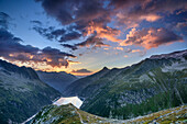 Mood of clouds above barrier lake Zillergrund, from hut Plauener Huette, Reichenspitze group, Zillertal Alps, Tyrol, Austria