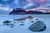 Rocks at beach, mountains in background, Lofoten, Norland, Norway