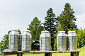 A timber house with milk churns, Radein, South Tyrol, Italy