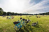 Fahrräder und Erholungssuchende auf der großen Wiese im Stadtpark, Hamburg, Deutschland
