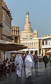 Men walking on Doha street, Doha, Qatar