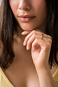 Hispanic woman resting hand on chin