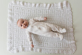 Caucasian baby laying on blanket