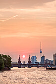 Sunset over the River Spree, view toward Oberbaum bridge and TV tower, Kreuzberg, Berlin, Germany