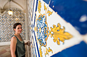 A woman admires beautuful Azelejo tiles on display at The National Azulejo Museum in Lisbon, Portugal, Europe
