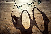 Shadow of glasses on a rustic table