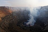Steam rising from active lava lake in the crater of Nyiragongo Volcano, Virunga National Park, North Kivu Province, Democratic Republic of Congo, Africa.