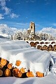 The church of San Gian surrounded by snowy woods Celerina Canton of Grisons Engadine Switzerland Europe.