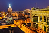 Overview at dusk of illuminated historic city of Valletta, Malta.
