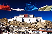 View of the rebuilt Dzong of Shigatse or Samdruptse Dzong with prayer flags in foreground. Shigatse, Tibet.