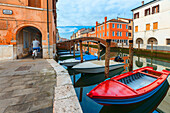 Europe, Italy, Veneto. Boats moored in a canal of Chioggia.