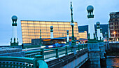 On background Kursaal Palace by the architect Rafael Moneo, Zurriola Bridge with streetlights Art Deco over river Urumea, Donostia, San Sebastian, Gipuzkoa, Basque Country, Euskadi, Spain, Europe.