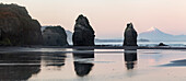 Rock formations and view of Mount Taranaki volcano, Tongaporutu, Taranaki, North Island, New Zealand, Oceania